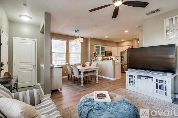 A living room with a television and a dining table.