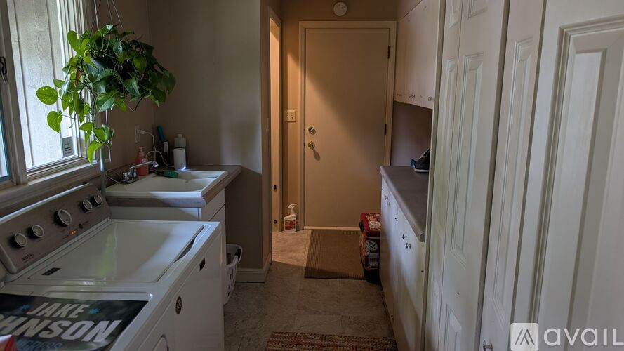 A kitchen with a stove top oven and a doorway leading to another room.