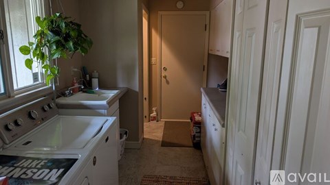 A kitchen with a stove top oven and a doorway leading to another room.