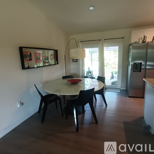 A dining room with a table and chairs.