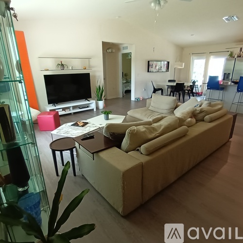 A living room with a large couch and a television.