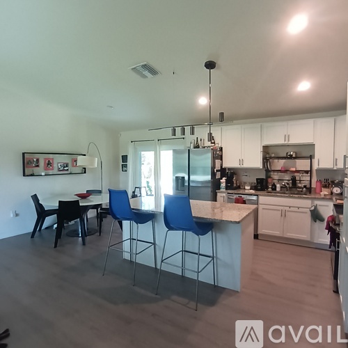 A kitchen with a table and chairs in the middle of the room.