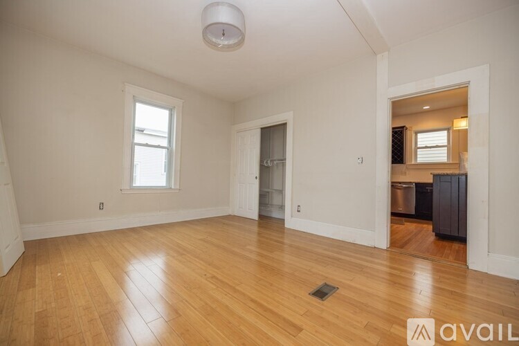 A room with wooden floors and a window.