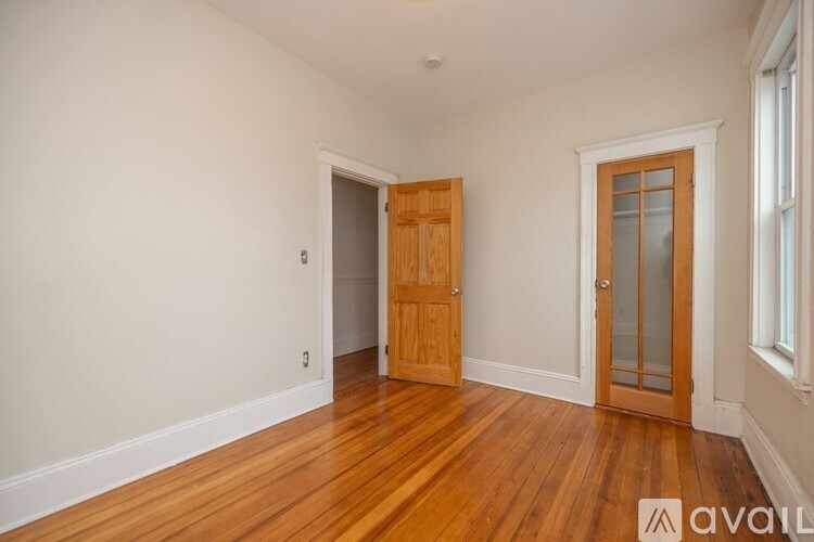 A room with wooden floors and a door.
