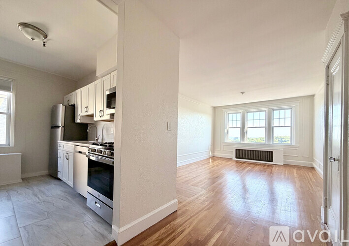 A kitchen with white cabinets and stainless steel appliances.