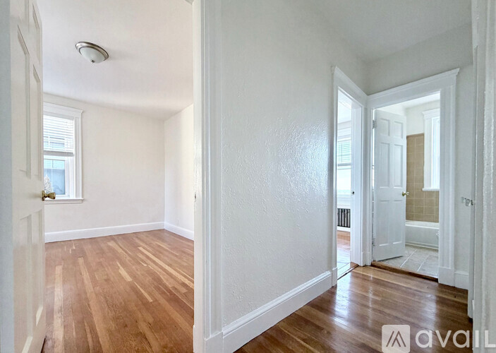 A room with wooden floors and white walls.