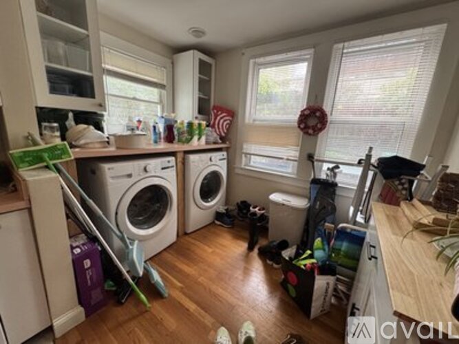 A laundry room with a washer and dryer stacked on top of each other.