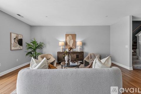 A living room with a grey couch and a wooden coffee table.