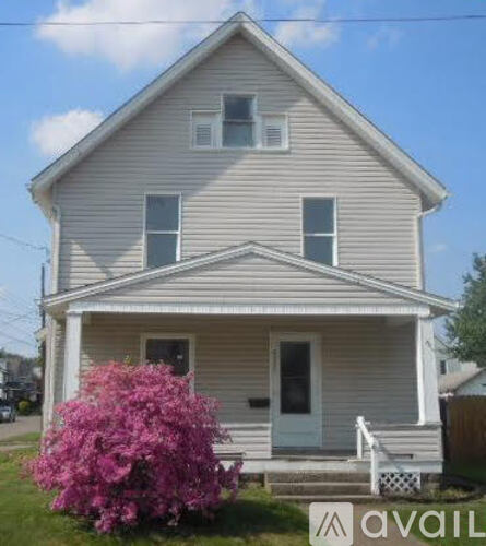 A house with a white door and windows is for sale.