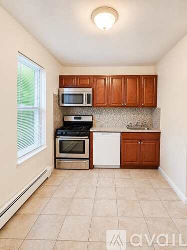 A kitchen with a microwave, oven, and dishwasher.