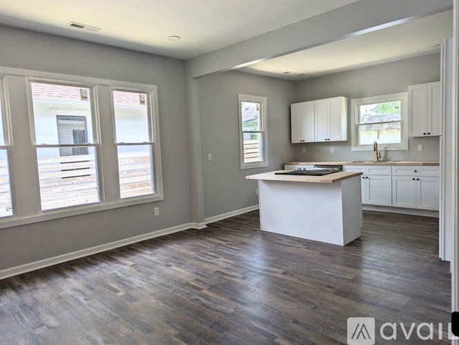 A kitchen with a white island in the middle of the room.