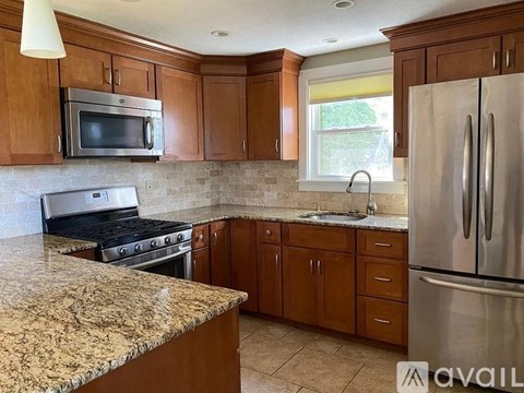 A kitchen with granite countertops and stainless steel appliances.