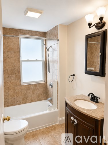A room with a granite countertop and wooden flooring.