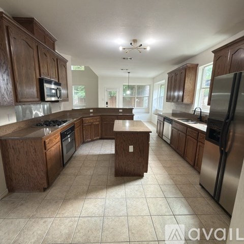A kitchen with wooden cabinets and a central island.