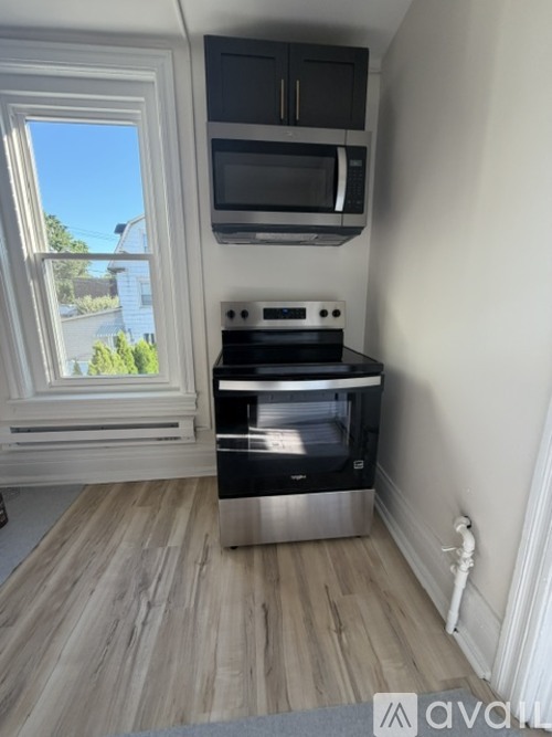 A kitchen with a stove top oven and microwave above it.
