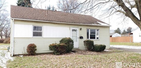 A small house with a white door and two windows.
