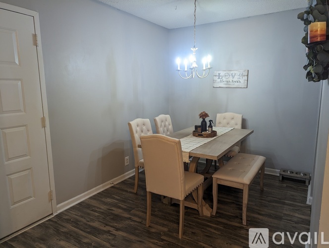 A dining room with a white table and chairs.