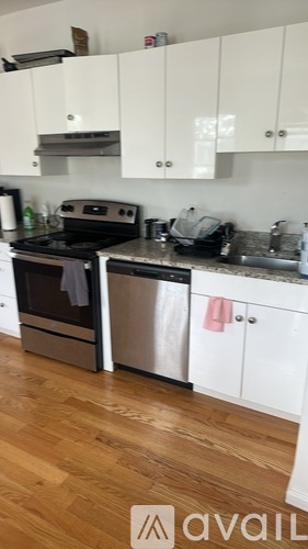 A kitchen with a stove, oven, and cabinets.