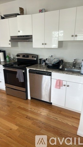 A kitchen with a stove, oven, and cabinets.