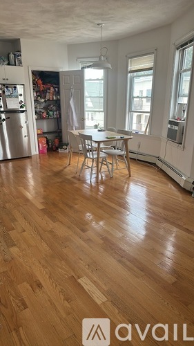 A kitchen with a table and chairs in the middle of the room.