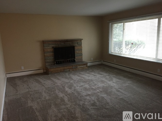 A living room with a fireplace and a flat screen TV.