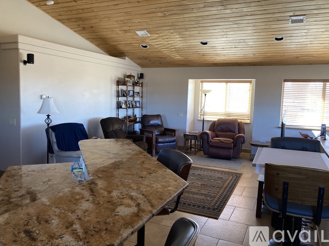 A living room with a table and chairs.