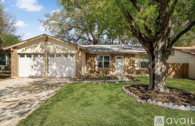 A house with a tree in front of it.