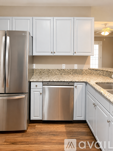 A kitchen with a stainless steel refrigerator and dishwasher.