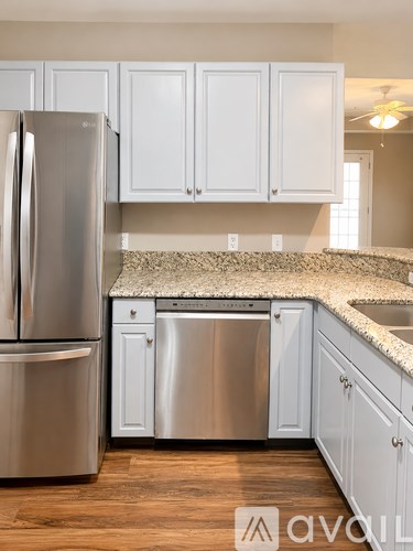 A kitchen with a stainless steel refrigerator and dishwasher.