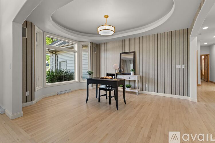 A dining room with a wooden table and chairs.