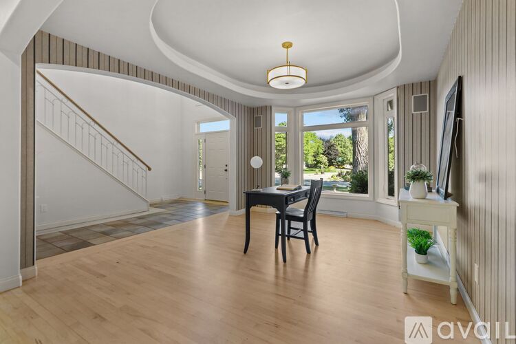 A spacious room with a wooden floor and a curved ceiling.