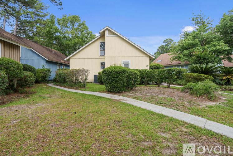 A house with a well-maintained lawn and a clear sky.