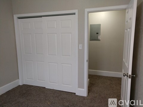 A white door with a mirror on the wall.
