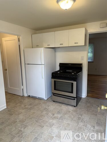 A kitchen with a white fridge and stove top oven.