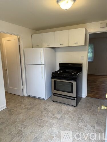 A kitchen with a white fridge and stove top oven.