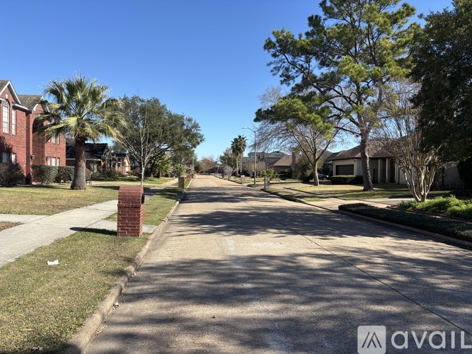 A street view of a residential area with houses on both sides.