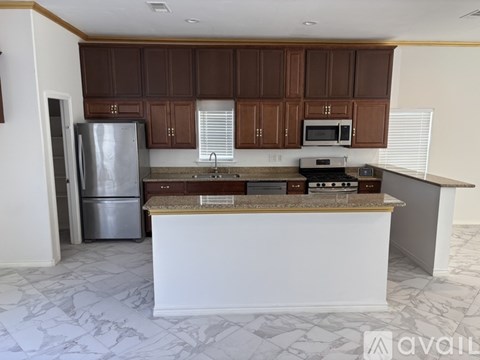 A kitchen with brown cabinets and a white island.