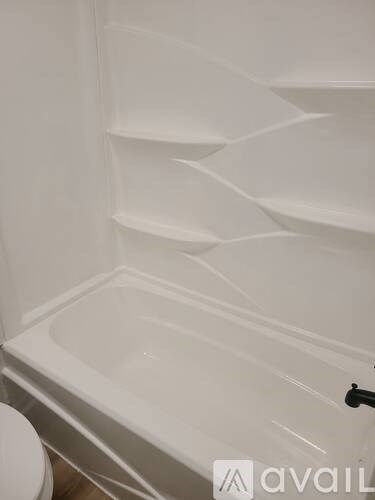 A white bathroom with a toilet and a bathtub.