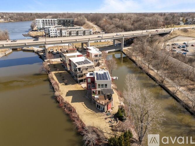 A river flows through a city with a bridge crossing over it.