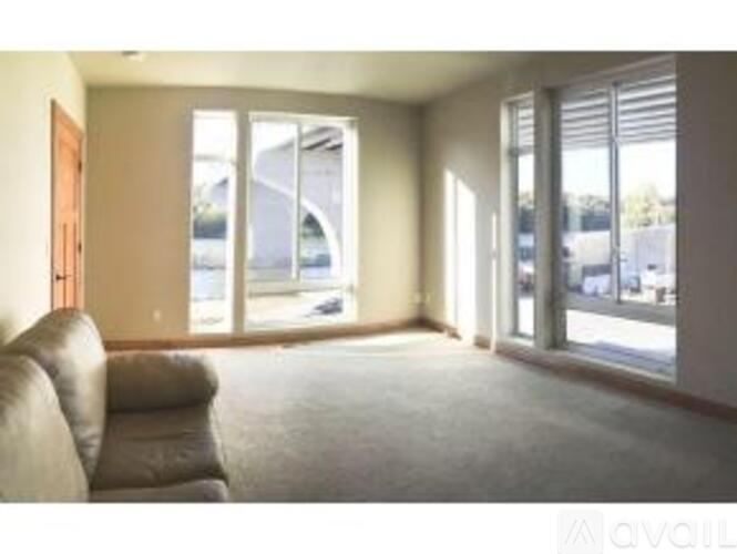 A living room with a couch and sliding glass doors.
