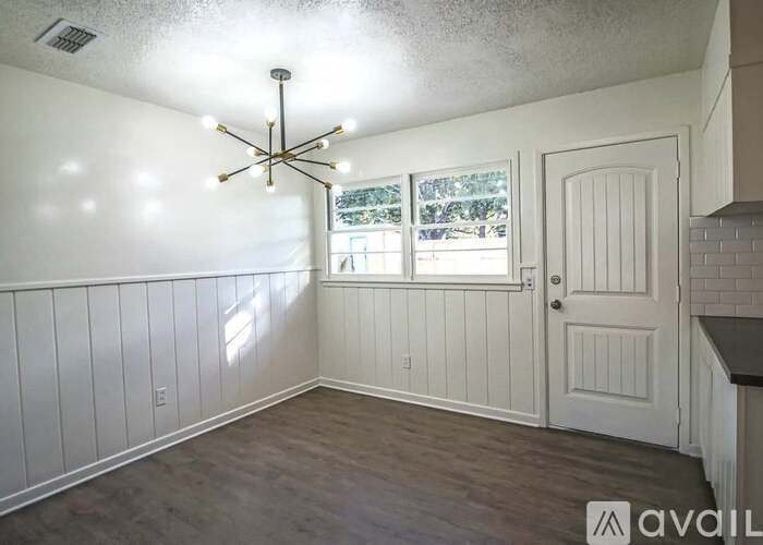 A room with a white ceiling and a chandelier.