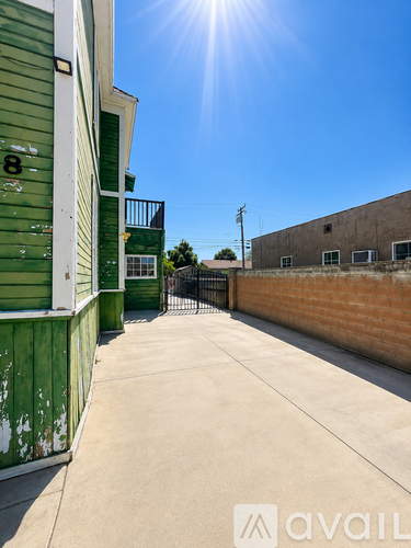 A sunny day at a green building with a clear blue sky.