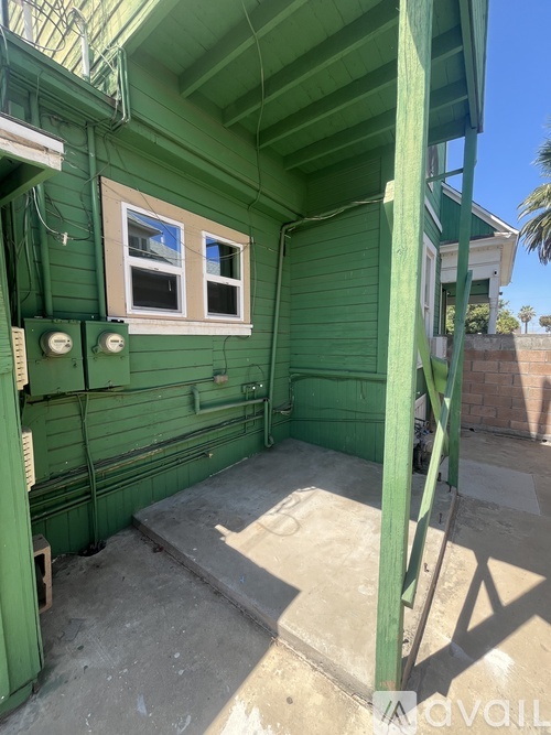 A green house with a window and a door.