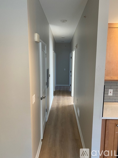 A long hallway with doors on both sides.