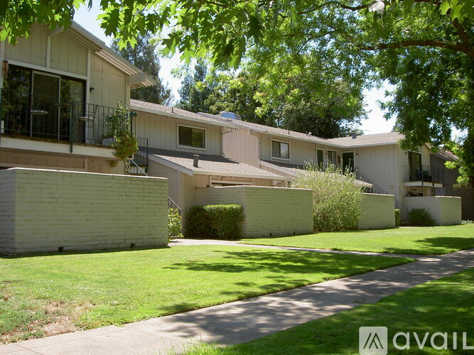 A row of houses with a green lawn in front.