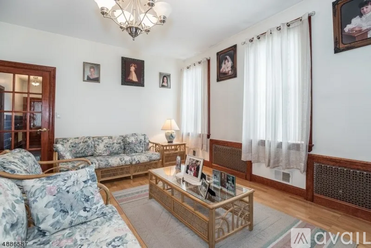 A living room with a sofa, a coffee table, and pictures on the wall.