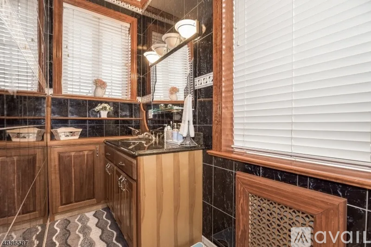 A kitchen with wooden cabinets and a black countertop.
