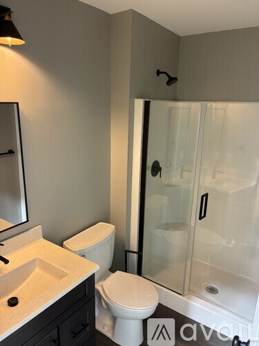 A white toilet sits next to a sink in a bathroom.