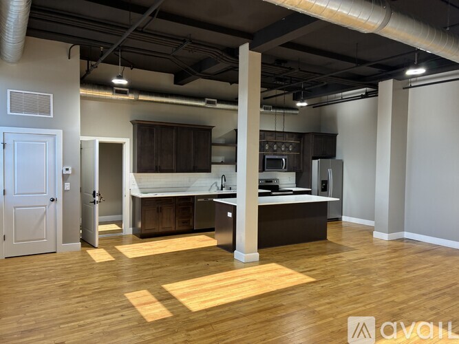 A spacious kitchen with wooden floors and a large island.