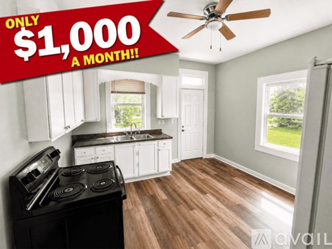 A kitchen with a stove top oven and a ceiling fan.